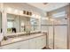 Spacious bathroom with double sinks, a glass-enclosed shower, and contemporary lighting at 223 Silver Maple Rd, Groveland, FL 34736