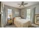 Cozy bedroom with natural light, neutral tones, and comfortable furnishings at 223 Silver Maple Rd, Groveland, FL 34736