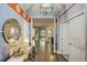 Inviting entryway featuring stylish decor, hardwood floors, and modern lighting at 223 Silver Maple Rd, Groveland, FL 34736