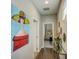 Hallway features hardwood floors, stylish decor, and a glimpse into the living space at 223 Silver Maple Rd, Groveland, FL 34736