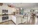 Open kitchen featuring an island with seating and stainless steel appliances at 223 Silver Maple Rd, Groveland, FL 34736
