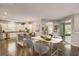 Open concept kitchen and dining area with wood floors and lots of natural light at 223 Silver Maple Rd, Groveland, FL 34736