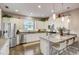 Bright kitchen with stainless appliances, white cabinetry, bar seating and hardwood flooring at 223 Silver Maple Rd, Groveland, FL 34736