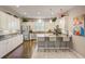 Bright kitchen with an island, stainless steel appliances, and white cabinetry at 223 Silver Maple Rd, Groveland, FL 34736