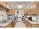 Functional laundry room with ample cabinet storage, washer, dryer, and sink at 223 Silver Maple Rd, Groveland, FL 34736