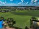 Scenic aerial shot of the community lawn surrounded by lush landscaping and homes in the distance at 223 Silver Maple Rd, Groveland, FL 34736