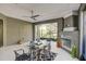Enclosed patio with a fireplace, tile flooring, and views of the backyard at 223 Silver Maple Rd, Groveland, FL 34736