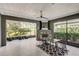 Enclosed patio with a fireplace, tile flooring, and views of the backyard at 223 Silver Maple Rd, Groveland, FL 34736