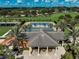 Community tennis court with shade structure next to a covered seating area, ideal for players and viewers at 223 Silver Maple Rd, Groveland, FL 34736