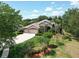 Stunning aerial view of the property showcasing a well-manicured lawn, mature trees, and a paver driveway at 2332 Pond Cove Way, Apopka, FL 32712