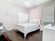Clean bedroom with hardwood floors, a bed, a desk, and a double door closet at 2332 Pond Cove Way, Apopka, FL 32712