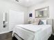 Bedroom with hardwood floors, has walk in closet with a large mirror, decorative pillows and a white bedspread at 2332 Pond Cove Way, Apopka, FL 32712