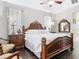 This hardwood-floored bedroom features unique vintage furniture that frames a queen sized bed under a ceiling fan at 2332 Pond Cove Way, Apopka, FL 32712