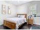 Bedroom with hardwood floors, natural light, and decoratively framed paintings to match the bed and a treadmill at 2332 Pond Cove Way, Apopka, FL 32712