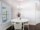 Bright dining room with a table and a chandelier near sliding glass doors at 2332 Pond Cove Way, Apopka, FL 32712