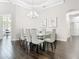 Elegant dining area showcasing a glass table with seating for six and stylish wall art at 2332 Pond Cove Way, Apopka, FL 32712