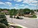 Community entrance with lush landscaping, elegant signage, and water feature, offering a grand arrival experience at 2332 Pond Cove Way, Apopka, FL 32712