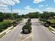 Gated entrance of a secure community, featuring well-manicured landscaping and pedestrian crossing at 2332 Pond Cove Way, Apopka, FL 32712