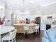 Spacious kitchen featuring an island with seating, white cabinets, and modern appliances at 2332 Pond Cove Way, Apopka, FL 32712