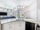 Kitchen island featuring granite countertops, white cabinets, and stainless steel appliances at 2332 Pond Cove Way, Apopka, FL 32712