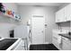 Well-organized laundry room with modern washer, dryer, ample storage, and sleek countertop space at 2332 Pond Cove Way, Apopka, FL 32712