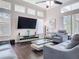 Bright living room featuring a flat screen tv, modern furniture, and hardwood floors at 2332 Pond Cove Way, Apopka, FL 32712