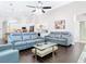 Open-concept living room featuring modern furniture and hardwood floors at 2332 Pond Cove Way, Apopka, FL 32712