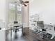 Bright office with tall ceilings, modern furniture, large windows, and dark wood flooring at 2332 Pond Cove Way, Apopka, FL 32712