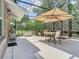 Screened patio features a table and chairs, providing a comfortable outdoor space at 2332 Pond Cove Way, Apopka, FL 32712