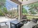 A covered patio with couches and chairs and a view of the backyard at 2332 Pond Cove Way, Apopka, FL 32712