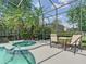 An in-ground pool and spa in a screened-in patio area at 2332 Pond Cove Way, Apopka, FL 32712