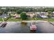 Waterfront home with a private dock, sandy beach, and lush green backyard at 2501 Trentwood Blvd, Belle Isle, FL 32812