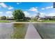 Scenic backyard view with a private dock, offering direct access to the tranquil lake waters at 2501 Trentwood Blvd, Belle Isle, FL 32812