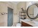 Bathroom featuring a tiled shower, vanity with oval mirror, and decorative accents at 2501 Trentwood Blvd, Belle Isle, FL 32812