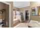 Well-lit bathroom featuring a soaking tub, glass-enclosed shower, and large vanity with sink at 2501 Trentwood Blvd, Belle Isle, FL 32812