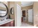 Bathroom with a large vanity, round mirror, and tile floors at 2501 Trentwood Blvd, Belle Isle, FL 32812
