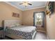 A tidy bedroom with a window, ceiling fan, and TV at 2501 Trentwood Blvd, Belle Isle, FL 32812