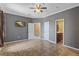 Bedroom with ceiling fan and a mounted television, and doorways leading to additional rooms at 2501 Trentwood Blvd, Belle Isle, FL 32812