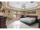 Spacious bedroom with tray ceiling, ceiling fan, dresser and large windows for natural light at 2501 Trentwood Blvd, Belle Isle, FL 32812