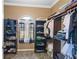 Walk-in closet with custom shelving, storage drawers, and hanging racks for organization at 2501 Trentwood Blvd, Belle Isle, FL 32812
