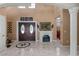 Spacious foyer with high ceilings, decorative fireplace, and elegant marble flooring at 2501 Trentwood Blvd, Belle Isle, FL 32812