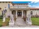 Grand entrance with stone accents, stately columns, and sculpted lion statues at 2501 Trentwood Blvd, Belle Isle, FL 32812