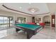 Game room featuring a pool table, lake views, and access to the pool at 2501 Trentwood Blvd, Belle Isle, FL 32812