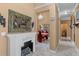 Hallway featuring white tile floors, fireplace, and view to a dining room with red chairs at 2501 Trentwood Blvd, Belle Isle, FL 32812