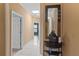 Well-lit hallway with modern decor, neutral walls, and white accents at 2501 Trentwood Blvd, Belle Isle, FL 32812