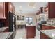 Eat in kitchen boasts granite countertops, an island, stainless appliances, and views of the water at 2501 Trentwood Blvd, Belle Isle, FL 32812
