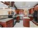 Modern kitchen with granite countertops, custom cabinets, stainless appliances, and a stylish range hood at 2501 Trentwood Blvd, Belle Isle, FL 32812