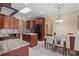 Open kitchen features granite counters, stainless steel appliances, and a center island with a breakfast bar at 2501 Trentwood Blvd, Belle Isle, FL 32812