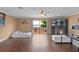 Spacious living room featuring wood floors, a waterfront view, and access to a balcony at 2501 Trentwood Blvd, Belle Isle, FL 32812