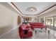 Large living room featuring white tile floors, two red couches and a billiard table at 2501 Trentwood Blvd, Belle Isle, FL 32812